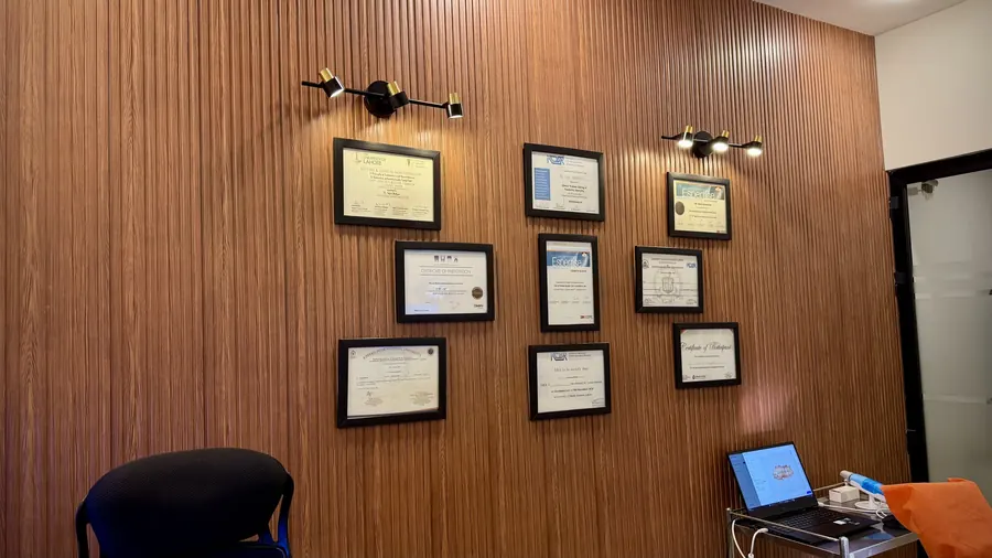 The credentials wall in Dr. Safia's surgery